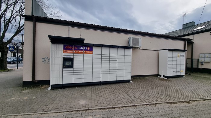 Paczkomat BEL23M Na parkingu przy sklepie odzieżowym