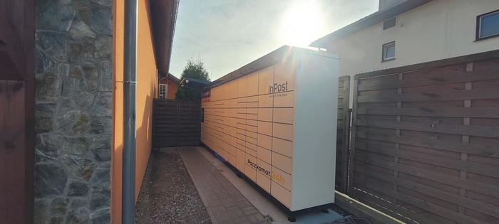 Paczkomat JSD02M Po lewej stronie od wejścia do sklepu.