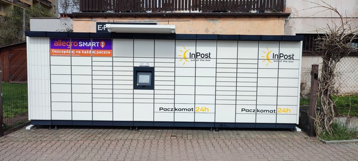 Paczkomat KRA379M W ogrodzeniu po prawej strony od bramy