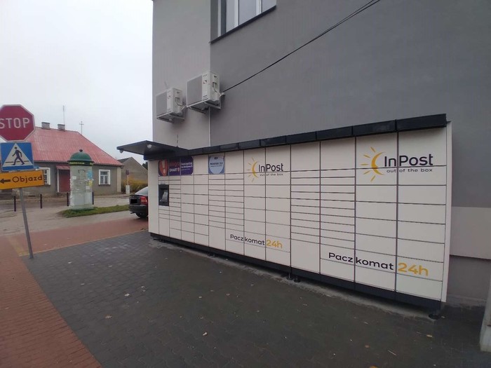 Paczkomat KUN01M Przy ścianie sklepu po prawej stronie budynku
