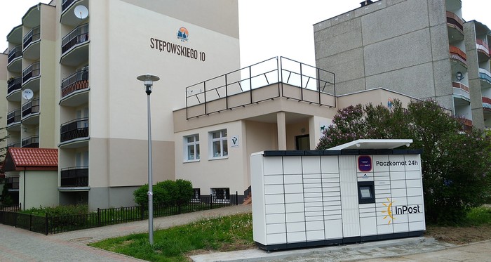 Paczkomat OST01M Pomiędzy blokami nr 6 i 10. Na przeciwko sklepu Warzywa i Owoce