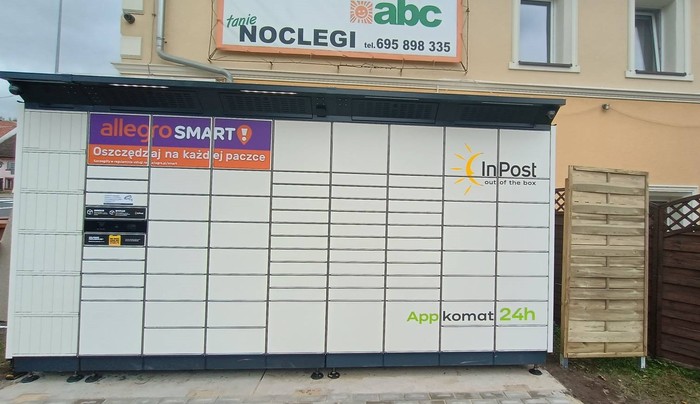 Paczkomat PASK01BAPP Przy sklepie spożywczym.
