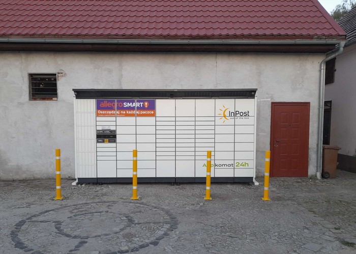 Paczkomat RDWQ01BAPP Po lewej stronie od sklepu.