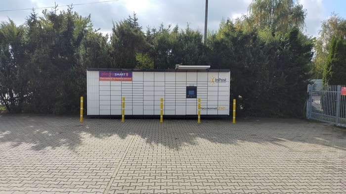Paczkomat WAW647M przy bramie, na parkingu