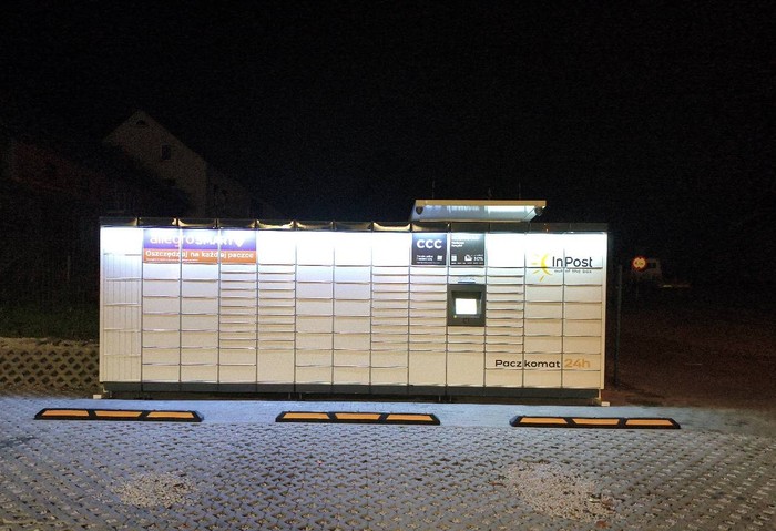 Поштомат XOE02M na parkingu przy sklepie spożywczym